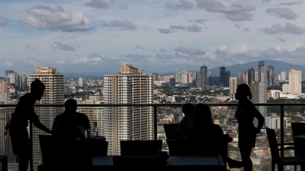 Customers at a rooftop bar in Manila. Photographer: SeongJoon Cho/Bloomberg