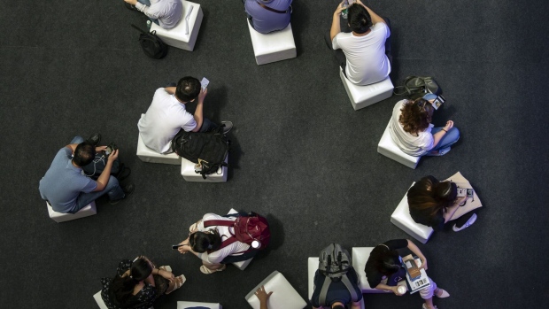 Attendees use smartphones at the World Artificial Intelligence Conference (WAIC) in Shanghai, China, on Thursday, July 8, 2021. The conference runs through to July 10. Photographer: Qilai Shen/Bloomberg