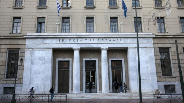 A Greek, left, and a European flag fly outside the headquarters of the Bank of Greece SA in Athens, Greece, on Wednesday, Jan. 22, 2020. After implementing three bailout programs during a decade of severe austerity, Greece will be the euro-area country with the largest fiscal expansion in 2020, according to Moody’s Investors Service. Photographer: Yorgos Karahalis/Bloomberg
