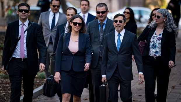 Meagan Bellshaw, assistant chief in the antitrust division at the US Department of Justice, center left, and Kenneth Dintzer, litigator for the US Department of Justice, center right, arrive to federal court in Washington, DC, US, on Monday, Oct. 30, 2023. Alphabet Inc.’s Chief Executive Officer Sundar Pichai sought to portray Google's position as the dominant internet search engine as constantly challenged by the whims of rivals such as Apple Inc., as he took the witness stand Monday to defend his company against the US governments antitrust charges.