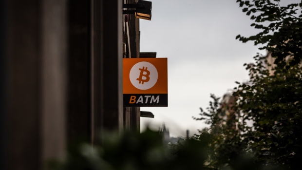 A Bitcoin automated teller machine (ATM) sign outside a cryptocurrency exchange in Barcelona, Spain, on Thursday, Sept. 8, 2022. The upcoming 'merge' will be the Ethereum blockchain's most ambitious software upgrade ever, with the upgrade representing a fundamental overhaul of how the Ethereum blockchain works.