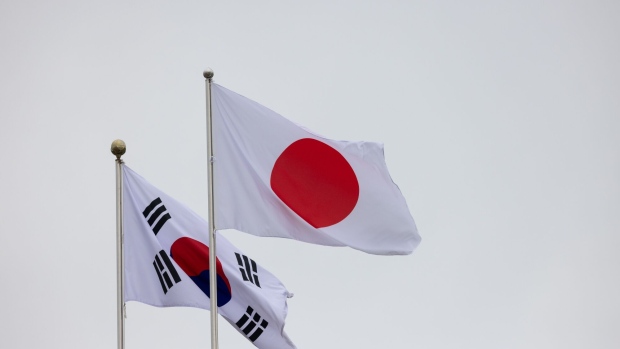 A Japanese national flag, left, and South Korean national flag at Seoul Air Base in Seongnam, South Korea, on Sunday, May 7, 2023. The second meeting in two months between leaders of Japan and South Korea after years without a formal summit marks another win for the Biden administration, which has sought to unite the allies to cooperate against North Korea and undercut China’s growing power. Photographer: SeongJoon Cho/Bloomberg