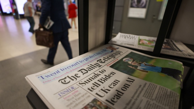 Copies of The Daily Telegraph newspaper on a newsstand in a shop in London, UK, on Thursday, June 8, 2023. The Telegraph newspapers and Spectator magazine could be sold, after a unit of Lloyds Banking Group Plc appointed receivers to a holding company and removed Barclay family members as directors of the media companies.