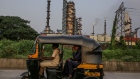 An autorickshaw drives past an oil refinery operated by Hindustan Petroleum Corp., in Mumbai, India, on Tuesday, Oct. 3, 2023. Oil prices need to fall to levels of around $80 a barrel to be good for consumers, India’s Oil Minister Hardeep Puri said, adding that the third largest consumer in the world will continue to buy where it finds the best prices. Photographer: Dhiraj Singh/Bloomberg