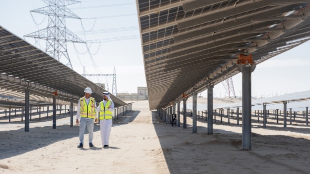 Abdulaziz Alobaidli, chief operating officer of Masdar, right, and Said Negar, site manager at the Dhafra solar park, at the Dhafra solar power plant near Abu Dhabi, United Arab Emirates, on Monday, Nov. 13, 2023. In June, Masdar and Taqa, the Abu Dhabi National Energy Co., began commercial operations at the 2-gigawatt Dhafra solar plant, developed with partners Jinko Power Co. and Electricite de France SA’s renewables arm and formally inaugurated it on Thursday.
