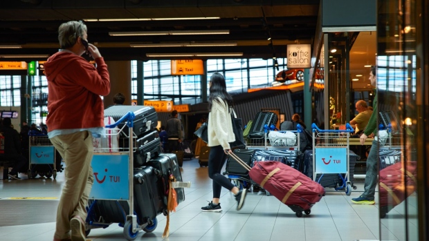 Passengers in the arrivals hall at Schiphol Airport in Amsterdam, Netherlands, on Thursday, April 6, 2023. Schiphol Airport, a key European transfer hub, plans to stop late night flights and ban private jets to reduce noise and lower CO2 emissions.