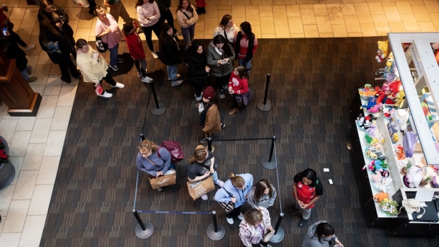 Shoppers wait in line outside a store at the Polaris Fashion Place mall in Columbus, Ohio.
