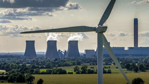 Wind turbines generate electricity near the Drax Power Station in Selby, England.