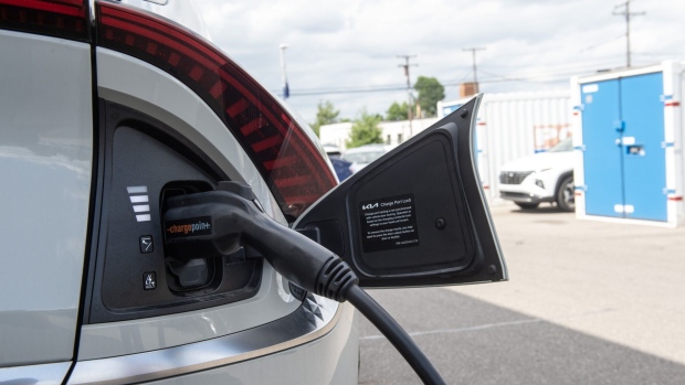 An electric vehicle is charged at a dealership in Detroit. Photographer: Matthew Hatcher/Bloomberg