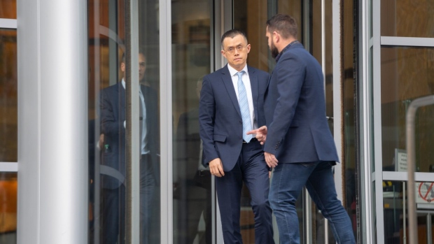 Changpeng Zhao, chief executive officer of Binance Holdings Ltd., center, exits federal court in Seattle, Washington, US, on Tuesday, Nov. 21, 2023. Zhao pleaded guilty to anti-money laundering violations and agreed to pay a $50 million fine Tuesday under a sweeping deal worked out with the Justice Department designed to keep the company operating. Photographer: Chloe Collyer/Bloomberg
