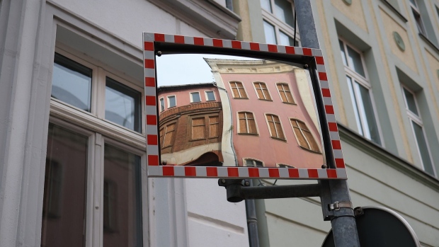 Abandoned residential houses reflected in a traffic mirror in Magdeburg, Germany, on Monday, Oct. 30, 2023. German inflation slowed markedly — and more than expected — in October as Europe’s biggest economy struggles to grow. Photographer: Krisztian Bocsi/Bloomberg
