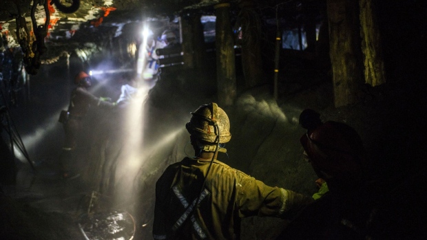 Lights from miners safety helmets illuminate the mine shaft during a media tour of the Sibanye-Stillwater Khuseleka platinum mine, operated by Sibanye Gold Ltd., outside Rustenburg, South Africa on Wednesday, Oct. 16 2019. Sibanye said it’s on track to resume paying dividends next year, should the company settle a wage dispute with platinum-mine workers without too much disruption.