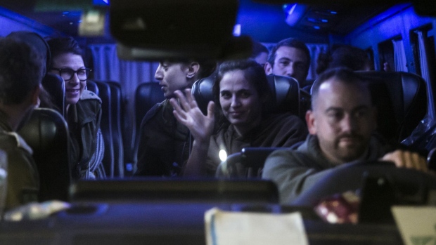 A van carries hostages released by Hamas from Gaza in Ofakim, Israel, on Nov. 30. Photographer: Amir Levy/Getty Images