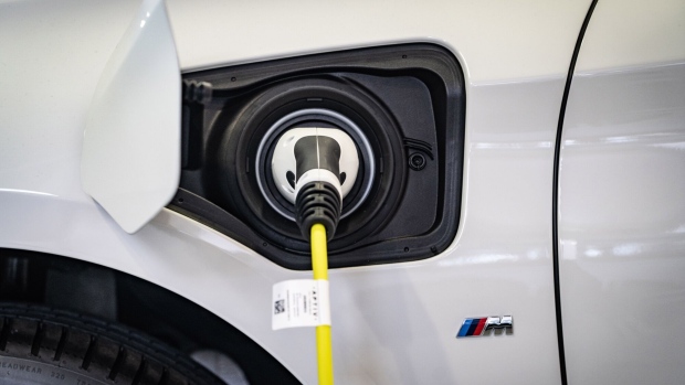 An electric charging plug sits connected to a BMW automobile inside a Bayerische Motoren Werke AG showroom in Frankfurt, Germany, on Tuesday, Aug. 4, 2020.  Photographer: Peter Juelich/Bloomberg