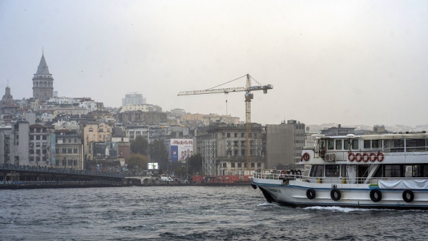 A construction crane viewed from the Bosphorus in Istanbul, Turkey, on Monday, Nov. 8, 2021. Prices in one of the world’s hottest property markets are poised to rise further after banks start slashing mortgage costs following last week’s interest rate cut, and citizens seek refuge against rampant inflation.