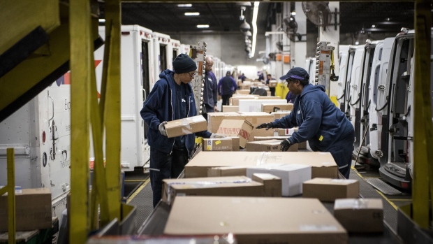 Employees sort packages in Chicago, Illinois. Photographer: Christopher Dilts/Bloomberg