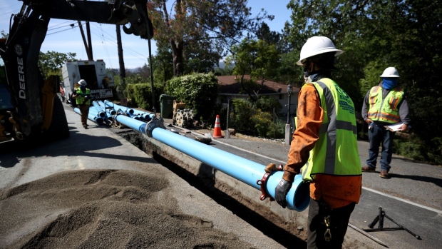WALNUT CREEK, CALIFORNIA - APRIL 22: Workers with East Bay Municipal Utility District (EBMUD) install new water pipe on April 22, 2021 in Walnut Creek, California. U.S. President Joe Biden introduced his $2 trillion infrastructure and jobs package that could potentially reshape the American economy. The American Jobs Plan is poised to repair aging roads and bridges, jump-start transit projects and rebuild school buildings and hospitals and would also expand electric vehicles, replace all lead pipes and overhaul the nation’s water systems. (Photo by Justin Sullivan/Getty Images)