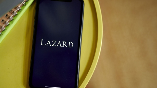 The Lazard logo on a smartphone arranged in the Brooklyn borough of New York, US, on Friday, April 28, 2023. Lazard Ltd. posted a surprise loss for the first quarter and said it plans to reduce its workforce by 10% this year, predicting the industrys dealmaking slump will last through 2023. Photographer: Gabby Jones/Bloomberg