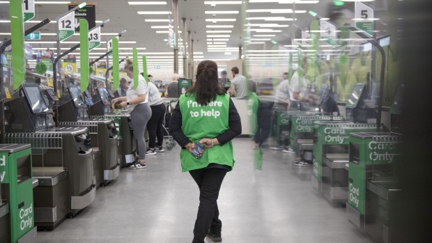 An employee supervises self-service checkout kiosks at a Woolworths Group Ltd. grocery store in Sydney, Australia, on Monday, Aug. 21, 2023. Woolworths is scheduled to release earnings results on Aug. 23.
