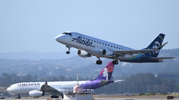 Alaska and Hawaiian Airlines planes takeoff from San Francisco International Airport (SFO) in San Francisco, California, United States on June 21, 2023. Photographer: Tayfun Coskun/Anadolu/Getty Images