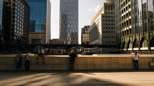 Commuters and pedestrians during a hot afternoon in the Canary Wharf business district of London, UK, on Tuesday, Aug. 22, 2023. Heat waves in the region are becoming more frequent and intense, creating livability issues in cities that have long gotten by without air-conditioning, where both old and new homes aren’t built for high heat. Photographer: Jose Sarmento Matos/Bloomberg