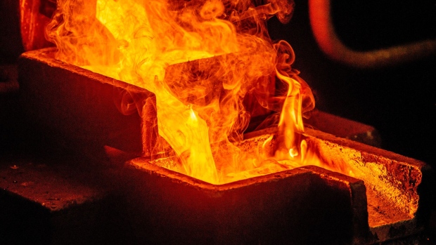 Liquid gold flows from a furnace into individual casting molds to create 28 kilogram gold bars in the foundry at the South Deep gold mine, operated by Gold Fields Ltd., in Westonaria, South Africa, on Thursday, March 9, 2017. South Deep is the world's largest gold deposit after Grasberg in Indonesia, makes up 60 percent of the company's reserves and the miner says it's capable of producing for 70 years. Photographer: Waldo Swiegers/Bloomberg