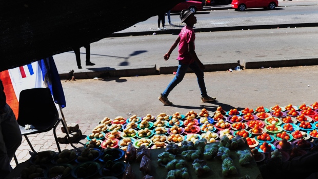 A street vendor sells fresh produce in the Alexandra township of Johannesburg, South Africa, on Wednesday, March 30, 2022. A campaign against foreigners is being led by Operation Dudula, an isiZulu word meaning “to push out.”, with the group carrying out raids on what it alleges are brothels, drug dens and trading stores run by foreigners in central Johannesburg and surrounding townships. Photographer: Leon Sadiki/Bloomberg