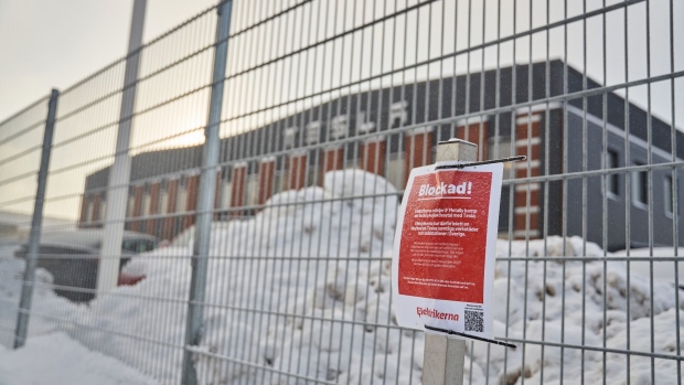 A strike placard from IF Metall union during a labor protest on security fencing outside the Tesla Inc. service center in Segeltorp, Sweden, on Tuesday, Dec. 5, 2023. Tesla's deliveries to Sweden are at risk of being blocked from across the Nordic region after unions asked their neighboring peers to bolster their weeks-long strike.
