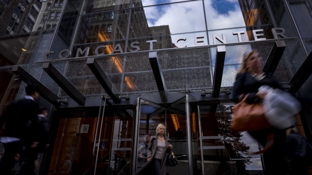 People exit Comcast Corp. headquarters in Philadelphia, Pennsylvania, U.S., on Monday, Oct. 24, 2016. Comcast Corp. is scheduled to release earnings figures on October 26.