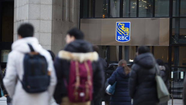 People walk by an RBC sign