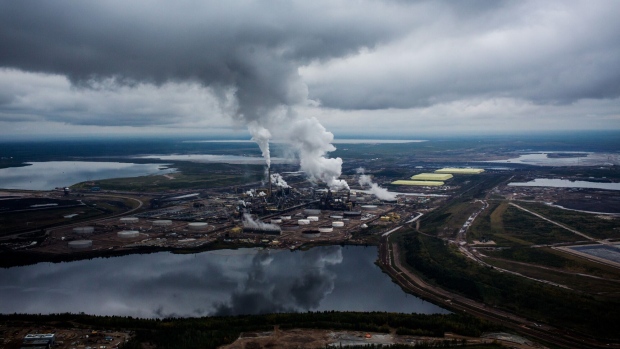 Steam rises from the Syncrude Canada Ltd. upgrader plant in this aerial photograph taken above the Athabasca oil sands near Fort McMurray, Alberta, Canada, on Monday, Sept. 10, 2018.