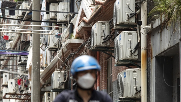 Air conditioner units at a building in Shanghai, China, on Friday, June 23, 2023. Extreme weather is already promising a fresh test of the electricity grid just months after heat waves and drought throttled hydropower and triggered widespread power shortages. Photographer: Qilai Shen/Bloomberg