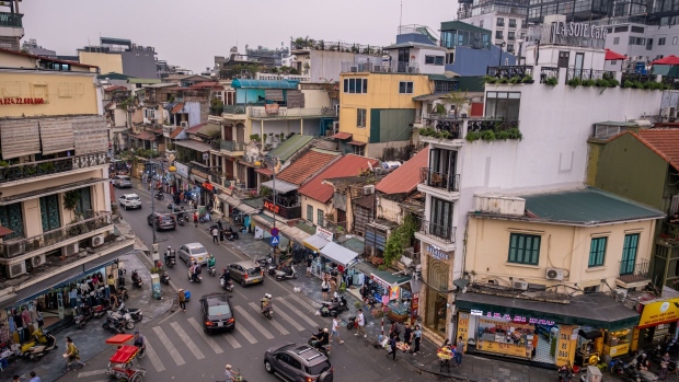 Vehicles drive along a road in the old quarter in Hanoi, Vietnam, on Tuesday, March 21, 2023. Vietnam is scheduled to release it's annual gross domestic product (GDP) figures on March 29.