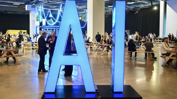 An illuminated AI sign during the All In event in Montreal, Quebec, Canada, on Thursday, Sept. 28, 2023. The event aims to connect people to real-life applications of Canadian AI in business, research and ethical pursuits. Photographer: Graham Hughes/Bloomberg