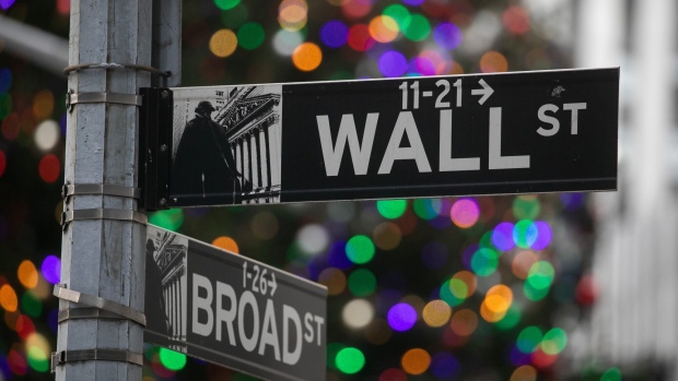 The Wall Street and Broad Street signs outside the New York Stock Exchange (NYSE) in New York, US, on Monday, Dec. 4, 2023. Stocks and bonds retreated as traders pause after Novembers blockbuster rally and debate the case for interest rate cuts.