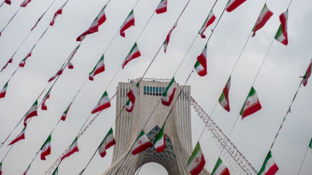 Iranian national flag bunting hangs in front of the Azadi Tower during the celebrations marking 40th anniversary of the Islamic revolution in Tehran, Iran, on Monday, Feb. 11, 2019. As Iran’s Islamic Republic enters a fifth decade, its energy industry has little to celebrate. Photographer: Ali Mohammadi/Bloomberg