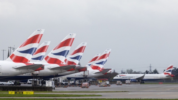 Passenger airplanes, operated by British Airways, at terminal 5 at London Heathrow Airport in London, UK, on Friday, March 31, 2023. British Airways is set to scrap 320 flights during the Easter week as security workers strike for 10-days over pay.