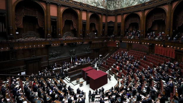 Members of Italy's parliament stand to applaud after a quorum was reached during the eighth round of voting to name a new president at the Chambers of Deputies in Rome, Italy, on Saturday, Jan. 29, 2022. Sergio Mattarella was re-elected as Italy’s president, offering relief to investors by setting up former European Central Bank head Mario Draghi to remain prime minister.