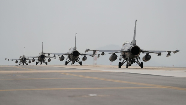 U.S. Air Force F-16 Fighting Falcon fighter jets, manufactured by Lockheed Martin Corp., taxi on the tarmac during the Max Thunder Air Exercise, a bilateral training exercise between the South Korean and U.S. Air Force, at a U.S. air base in Gunsan, South Korea, on Thursday, April 20, 2017. U.S. Vice President Mike Pence issued a fresh warning to North Korea from the deck of a U.S. aircraft carrier in Japan, hours after reports emerged that the approaching "armada" that President Donald Trump touted last week was still thousands of miles away. Photographer: SeongJoon Cho/Bloomberg