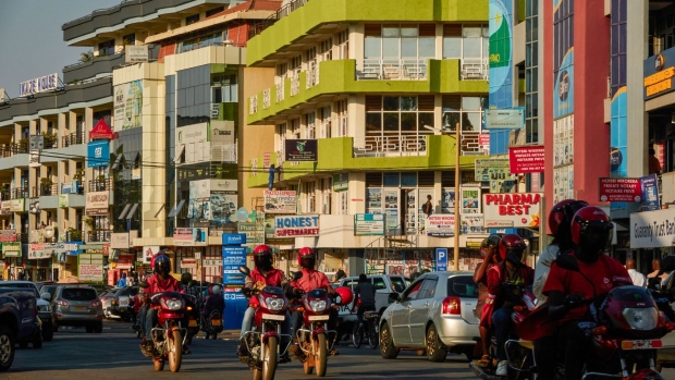 Moto taxis and automobiles pass commercial buildings in the Gasabo district of Kigali, Rwanda on Tuesday, July 18, 2023. The World Bank cut Rwanda's GDP growth estimate to 5.8% from 6.2%, as it expected flooding during April and May to result in slowed economic expansion.