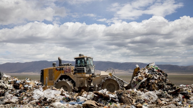 A worker operates a bulldozer to move trash at the Intermountain Regional Landfill in Fairfield, Utah, U.S., on Tuesday, June 30, 2020. Intermountain is working with Atlas ID, a software company that had focused on employment verification systems before the pandemic, to work out how often to test employees and in which scenarios. It'll cost about $2,000 a round. Photographer: Kim Raff/Bloomberg