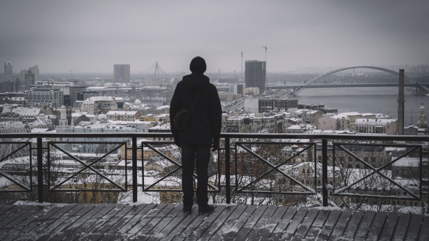 A visitor looks out towards the city skyline following heavy snowfall in Kyiv, Ukraine, on Wednesday, Nov. 22, 2023. The frosty temperatures poised to grip most of Europe by the weekend will drop even further next week, boosting energy demand during the winter’s first cold snap.