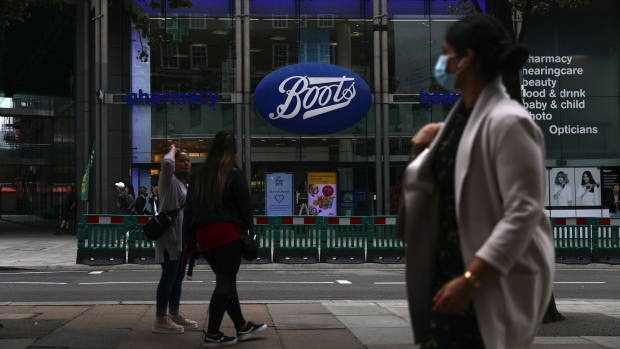 A pedestrian wearing a protective face passes a Boots pharmacists, operated by Walgreens Boots Alliance Inc., on Oxford Street in London, U.K., on Thursday, July 9, 2020. British shops aren't getting much of a boost from newly reopened bars, cafes and restaurants as customers prefer to stay away.