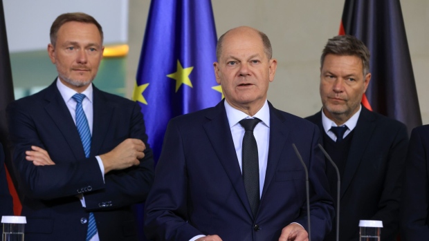 Olaf Scholz, Germany's chancellor, center, flanked by Christian Lindner, Germany's finance minister, left, and Robert Habeck, Germany's economy minister, during a news conference in Berlin, Germany, on Wednesday, Nov. 8, 2023. Scholz’s advisers joined a host of other organizations in downgrading their outlook for the German economy, cutting their forecast for this year to a contraction of 0.4% and predicting a significantly weaker-than-expected recovery in 2024. Photographer: Krisztian Bocsi/Bloomberg