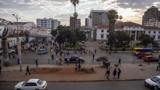 Pedestrians and a highway in the central business district of Harare, Zimbabwe, on Wednesday, July 5, 2023. Consumer prices are climbing at an annual pace of over 100%, sparking jitters in a nation where the scars of hyperinflation run deep.