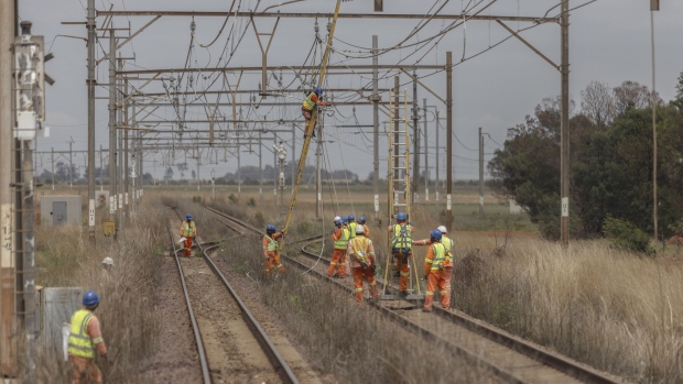 Workers repair sabotaged electrical cables on the central corridor rail freight line in Gauteng, South Africa on Nov. 17. 