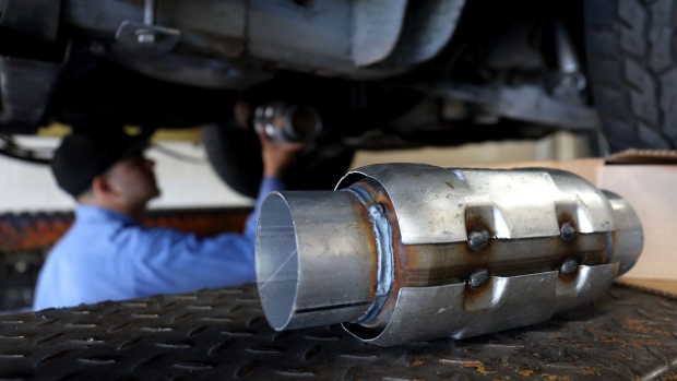 A mechanic prepares to install a catalytic converter onto a car in San Rafael, California.