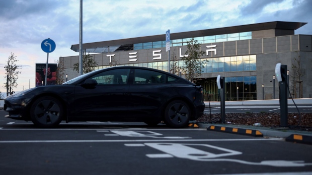 A Tesla Inc. electric vehicle outside the company's Gigafactory in Gruenheide, Germany, on Tuesday, Nov. 7, 2023. Tesla will produce a new model that will cost €25,000 ($26,863) at its factory near Berlin, Reuters reported, as competition intensifies to produce more affordable electric vehicles for the European market. Photographer: Liesa Johannssen-Koppitz/Bloomberg