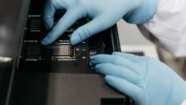 A technician places a flow cell glass slide into an Illumina Inc. DNA sequencing machine inside the Plasma Nucleic Acids laboratory in the Li Ka Shing Institute of Health Sciences at the Chinese University of Hong Kong in Hong Kong, China, on Tuesday, June 20, 2017. A study led by Hong Kong-based researchers and published this week in the New England Journal of Medicine used DNA fragments in the blood to detect a kind of head and neck cancer called nasopharyngeal carcinoma. The procedure, known as a "liquid biopsy," caught the cancer earlier and more accurately than existing methods -- and ultimately boosted patients' chances of survival.