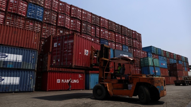 A forklift moves a shipping container at a depot in the Bang Na district of Bangkok, Thailand, on Friday, May 26, 2023. Thailand is scheduled to announce export figures on May 31. Photographer: Valeria Mongelli/Bloomberg
